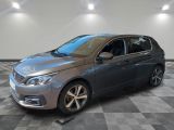 a grey car is parked in a room with a checkered floor