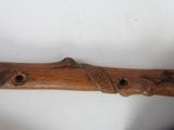 a close up of a wooden stick with holes in it
