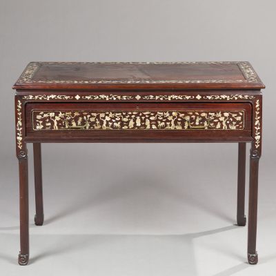 a small table with a wooden top and a floral design on the top