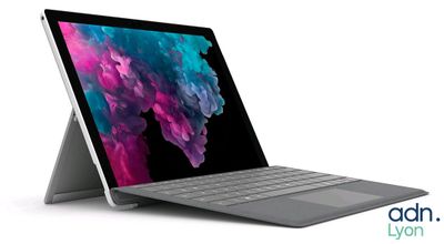 a laptop with a keyboard sitting on top of it