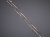 a gold necklace with a star design on it