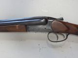 a close up of a gun on a table with a white background