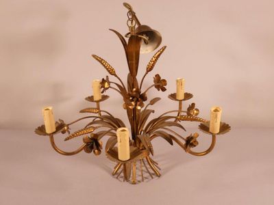 an image of a chandelier with candles and flowers on it