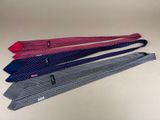 four ties are lined up in a row on a table
