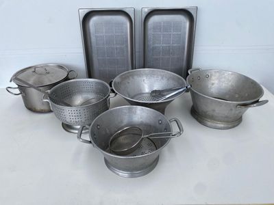 a lot of pots and pans sitting on a table
