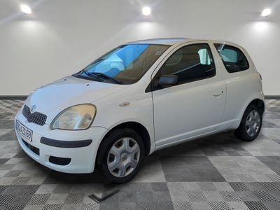a picture of a small white car parked in a garage