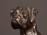 a statue of a dog that is sitting on a table