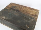 an old wooden box sitting on top of a table