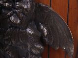 a statue of a man with a beard on a wooden wall