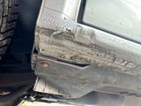 a close up view of a car ' s bumper and tire