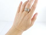 a woman ' s hand that is holding a diamond ring