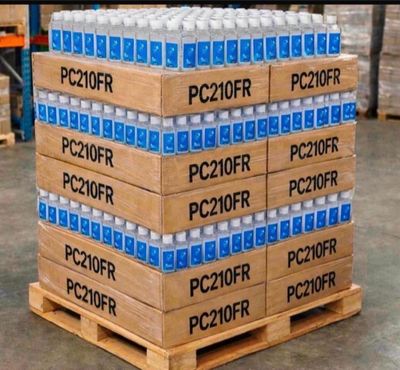 several boxes of water are stacked on a pallet in a warehouse