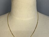 a gold chain necklace on a mannequin mannequin mannequin mannequin mannequin mannequin mannequin mannequin manne