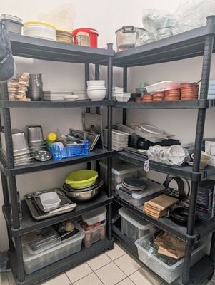 a kitchen with a lot of dishes on the shelves