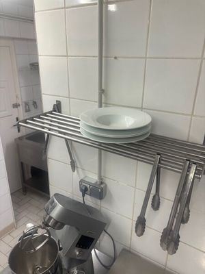 a kitchen with a sink and a mixer on the counter