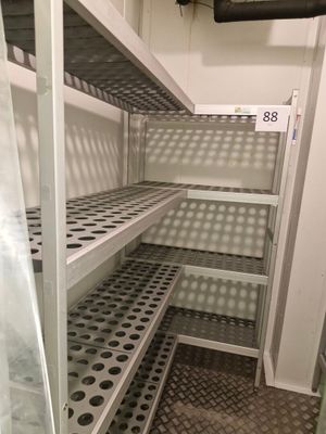a metal shelf in the middle of a room with lots of shelves