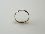 a close up of a gold ring on a white surface