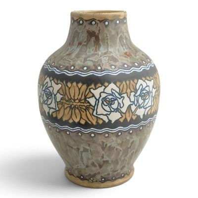 a vase that is sitting on a white surface