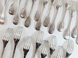 a lot of forks and spoons on the table