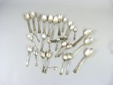 a lot of silver spoons and spoon spoons on the table
