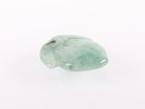 a close up of a piece of green jade on a white surface
