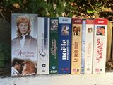 a lot of dvds on a shelf next to a fence