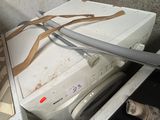 a dirty washer and dryer in a dirty room