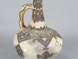 a white and brown vase with a design on it