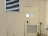 a small building that has a door and a window