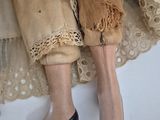 a close up of a doll ' s legs wearing high heels