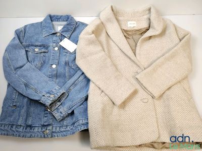 two jackets and a jacket sitting on top of a white table