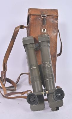pair of binoculars with leather case and strap on a white background