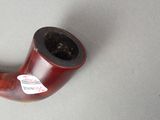 a pipe that is sitting on a table with a sticker on it