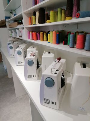 many spools of thread on the shelves in the sewing room