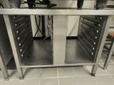 a stainless steel table with drawers on it in a kitchen