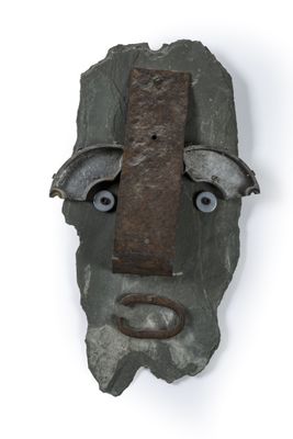 an image of a mask made out of a rock