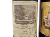 two bottles of wine sitting next to each other on a table