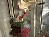a bird that is flying over a bird house