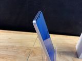 two cell phones that are sitting on a wooden table