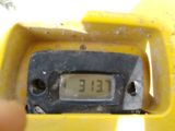 a close up of a yellow clock on the side of a building