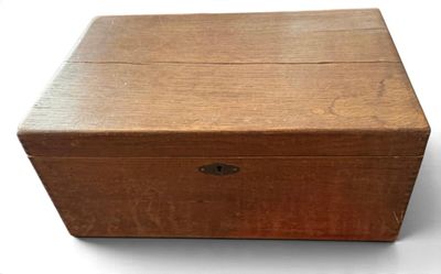 an old wooden box sitting on top of a white surface