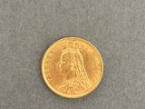 a close up of a gold coin on a gray surface