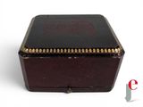 a small black box with gold trimmings on it