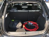 a trunk of a car with a hose in the trunk