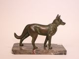 statue of a dog on a marble base on a white background