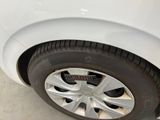 a close up of a tire on a white car