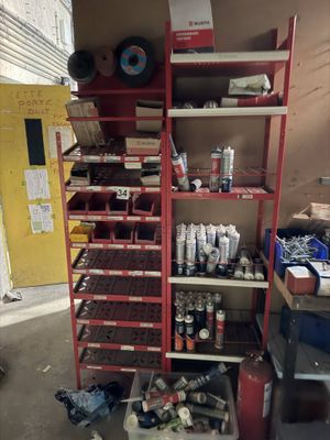 a red shelving with lots of items on top of it