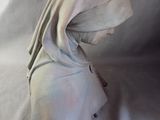 a white cloth covering a person ' s head on a white sheet