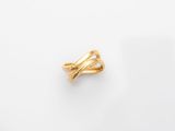 a gold ring on a white surface