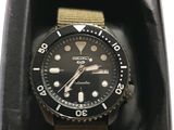 a black watch in a black box on a white background
